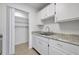 Bright kitchen features white cabinets, granite countertops, and stainless steel sink at 1550 11Th Ne St # G6, Winter Haven, FL 33881
