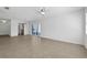 Spacious living room with tile flooring, a ceiling fan, and sliding glass doors to the outside at 1550 11Th Ne St # G6, Winter Haven, FL 33881