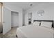 Comfortable bedroom featuring neutral colors, a round mirror, and a walk-in closet at 1744 Cross Prairie Pkwy, Kissimmee, FL 34744
