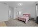 Bright bedroom with a pink bed and a bedside table on a carpeted floor at 1744 Cross Prairie Pkwy, Kissimmee, FL 34744