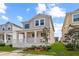 Charming two-story home featuring a covered front porch, neutral siding, and well-manicured landscaping at 1744 Cross Prairie Pkwy, Kissimmee, FL 34744