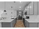 Modern kitchen with gray cabinets, stainless steel appliances, and a large island at 1744 Cross Prairie Pkwy, Kissimmee, FL 34744