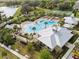Aerial view of a community pool, splash pad, tennis court, and surrounding greenery at 1744 Cross Prairie Pkwy, Kissimmee, FL 34744
