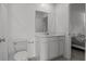 Well-lit bathroom features a white vanity with storage, a large mirror, and neutral tiling at 1998 Sarah St, Winter Haven, FL 33884