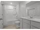 Bright bathroom showcases a shower-tub, white vanity with storage, and sleek fixtures at 1998 Sarah St, Winter Haven, FL 33884