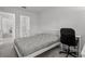 Comfortable bedroom adjacent to bathroom includes a bed and modern desk, ideal for flexible living at 1998 Sarah St, Winter Haven, FL 33884