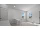 A bright dining area features a table with four chairs with natural light from two windows at 1998 Sarah St, Winter Haven, FL 33884