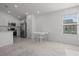 A bright dining area featuring a table with four chairs with stainless steel appliances in the kitchen at 1998 Sarah St, Winter Haven, FL 33884
