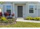 Close up of home's entry door, walkway, and landscaped flower beds at 1998 Sarah St, Winter Haven, FL 33884
