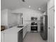 Kitchen featuring stainless steel appliances, a kitchen island, and neutral tiled flooring at 1998 Sarah St, Winter Haven, FL 33884