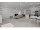 Open concept living room with neutral color palette, dining table, and kitchen island at 1998 Sarah St, Winter Haven, FL 33884