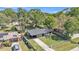 Aerial view of the home showing a fenced yard and long driveway with carport at 210 Pinehurst Dr, Auburndale, FL 33823