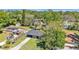 Aerial view of home and surrounding landscape with a lush backyard and long driveway at 210 Pinehurst Dr, Auburndale, FL 33823