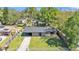 Aerial view of a charming home with a lush backyard and covered parking space at 210 Pinehurst Dr, Auburndale, FL 33823