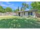 Exterior view highlighting the house with long driveway and fenced yard at 210 Pinehurst Dr, Auburndale, FL 33823