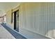 Exterior of the home's entryway with a black front door and security features at 210 Pinehurst Dr, Auburndale, FL 33823