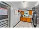 Traditional kitchen with wooden cabinets, white tile floors and a window providing natural light at 210 Pinehurst Dr, Auburndale, FL 33823