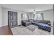Open-concept living room with gray sofa, tile flooring, and natural light from the windows at 210 Pinehurst Dr, Auburndale, FL 33823