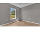 Bedroom with neutral walls and a sunlit window with backyard views, inviting relaxation at 225 Babson Dr, Babson Park, FL 33827