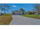 A well-manicured front lawn leads to a modern single-story home with a concrete driveway at 225 Babson Dr, Babson Park, FL 33827