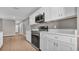 Modern kitchen featuring stainless steel appliances, white cabinets, and granite countertops at 225 Babson Dr, Babson Park, FL 33827