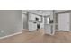 Open kitchen with white cabinetry, stainless steel appliances, and hardwood floors at 225 Babson Dr, Babson Park, FL 33827