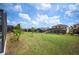 Large backyard features lush landscaping, a screened-in pool, and a covered patio at 225 Highgate Park Blvd, Davenport, FL 33897