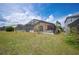 Spacious backyard showcases a screened-in pool, covered lanai, and lush greenery at 225 Highgate Park Blvd, Davenport, FL 33897