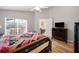 This bedroom boasts access to a patio and includes a dark dresser and ceiling fan at 225 Highgate Park Blvd, Davenport, FL 33897