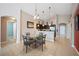 Open dining area, decorative lighting, and access to kitchen at 225 Highgate Park Blvd, Davenport, FL 33897
