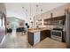 Open kitchen with stainless appliances and views into the living area at 225 Highgate Park Blvd, Davenport, FL 33897