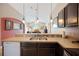Bright kitchen with stainless steel appliances, dark cabinets, and an open layout at 225 Highgate Park Blvd, Davenport, FL 33897