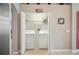 Bright laundry room features white washer and dryer, shelving, and easy access at 225 Highgate Park Blvd, Davenport, FL 33897