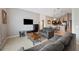 Spacious living room with a TV, tile floors, and an open concept to the kitchen area at 225 Highgate Park Blvd, Davenport, FL 33897