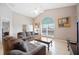 Bright living room featuring neutral walls, vaulted ceiling, and comfortable seating at 225 Highgate Park Blvd, Davenport, FL 33897