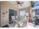 Covered patio boasts a ceiling fan and comfortable seating for outdoor dining at 225 Highgate Park Blvd, Davenport, FL 33897