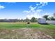 Backyard features a large, well-maintained lawn with a shed, landscaping, and trees at 238 Lake Eloise Pointe Blvd, Winter Haven, FL 33880
