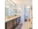 Bathroom featuring dual sinks, and a spacious vanity with dark wood cabinets at 238 Lake Eloise Pointe Blvd, Winter Haven, FL 33880