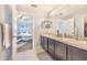 Bathroom featuring dual sinks, a large mirror, and access to the bedroom and closet at 238 Lake Eloise Pointe Blvd, Winter Haven, FL 33880