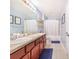 Bathroom with double vanity, framed mirrors, updated fixtures, and neutral tile floor at 238 Lake Eloise Pointe Blvd, Winter Haven, FL 33880