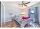 This bedroom features natural light from a window and wood-look flooring at 238 Lake Eloise Pointe Blvd, Winter Haven, FL 33880