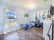 Cozy bedroom with wood-look floors and a large window providing natural light at 238 Lake Eloise Pointe Blvd, Winter Haven, FL 33880