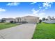 Beautiful home exterior with a well-maintained lawn and long driveway at 238 Lake Eloise Pointe Blvd, Winter Haven, FL 33880