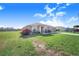 Charming home exterior showcasing the lawn and landscaping with an attached garage at 238 Lake Eloise Pointe Blvd, Winter Haven, FL 33880