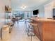 Open-concept layout with a kitchen island and living area with a sliding glass door at 238 Lake Eloise Pointe Blvd, Winter Haven, FL 33880