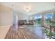 Bright living room boasts wood floors, a ceiling fan, and sliding glass doors to the backyard at 238 Lake Eloise Pointe Blvd, Winter Haven, FL 33880