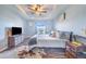 This bedroom has ample natural light, wood-look floors, and an ensuite bathroom at 238 Lake Eloise Pointe Blvd, Winter Haven, FL 33880
