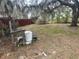 Spacious backyard featuring mature trees and ample green space, perfect for outdoor activities and relaxation at 261 Acacia Walk, Lake Wales, FL 33898