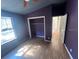 This bedroom features hardwood floors, fresh paint, natural light, and closet at 261 Acacia Walk, Lake Wales, FL 33898