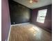 Bedroom with light purple walls, wood laminate flooring, and a window to the exterior at 261 Acacia Walk, Lake Wales, FL 33898